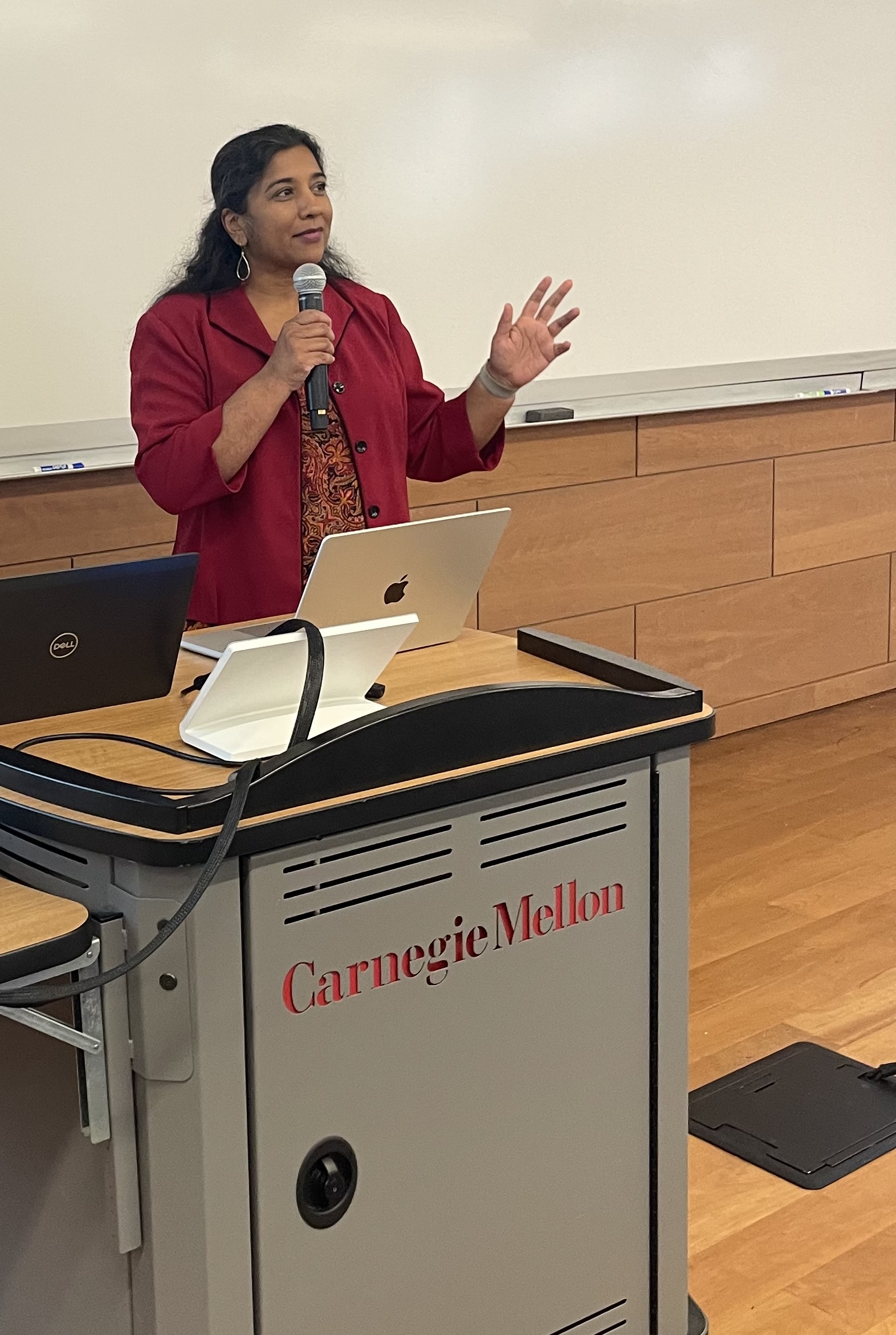 Arvita Tripati speaking at a Carnegie Mellon University lectern, mid-gesture