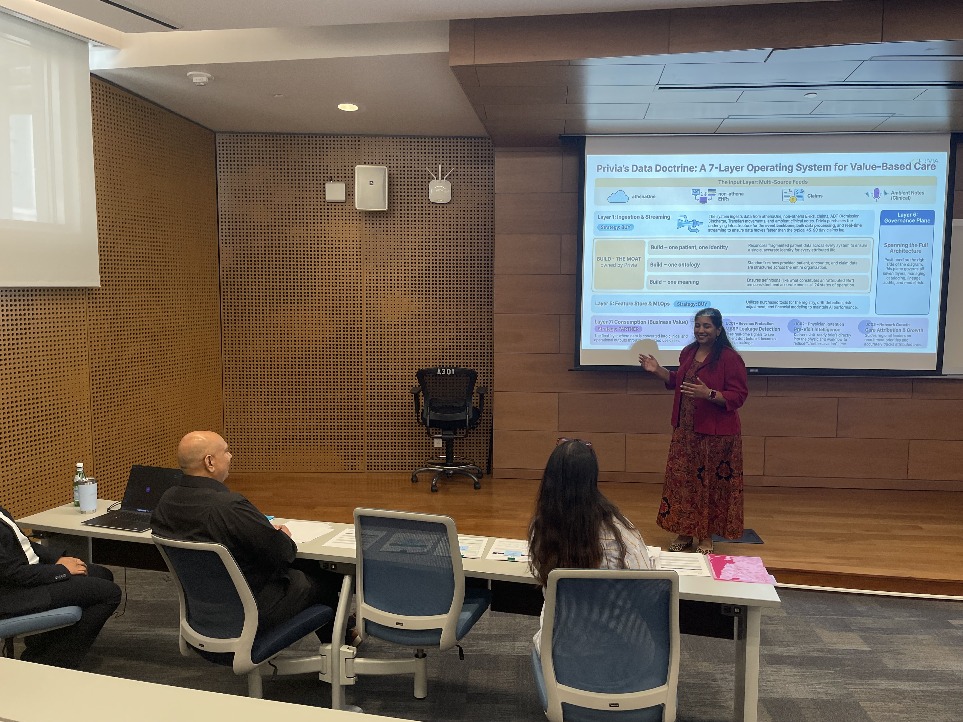Arvita Tripati leading an executive session at Carnegie Mellon University, presenting a seven-layer data architecture to a small seated audience